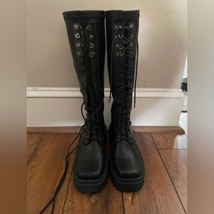 Knee high, lace up black platform boots
